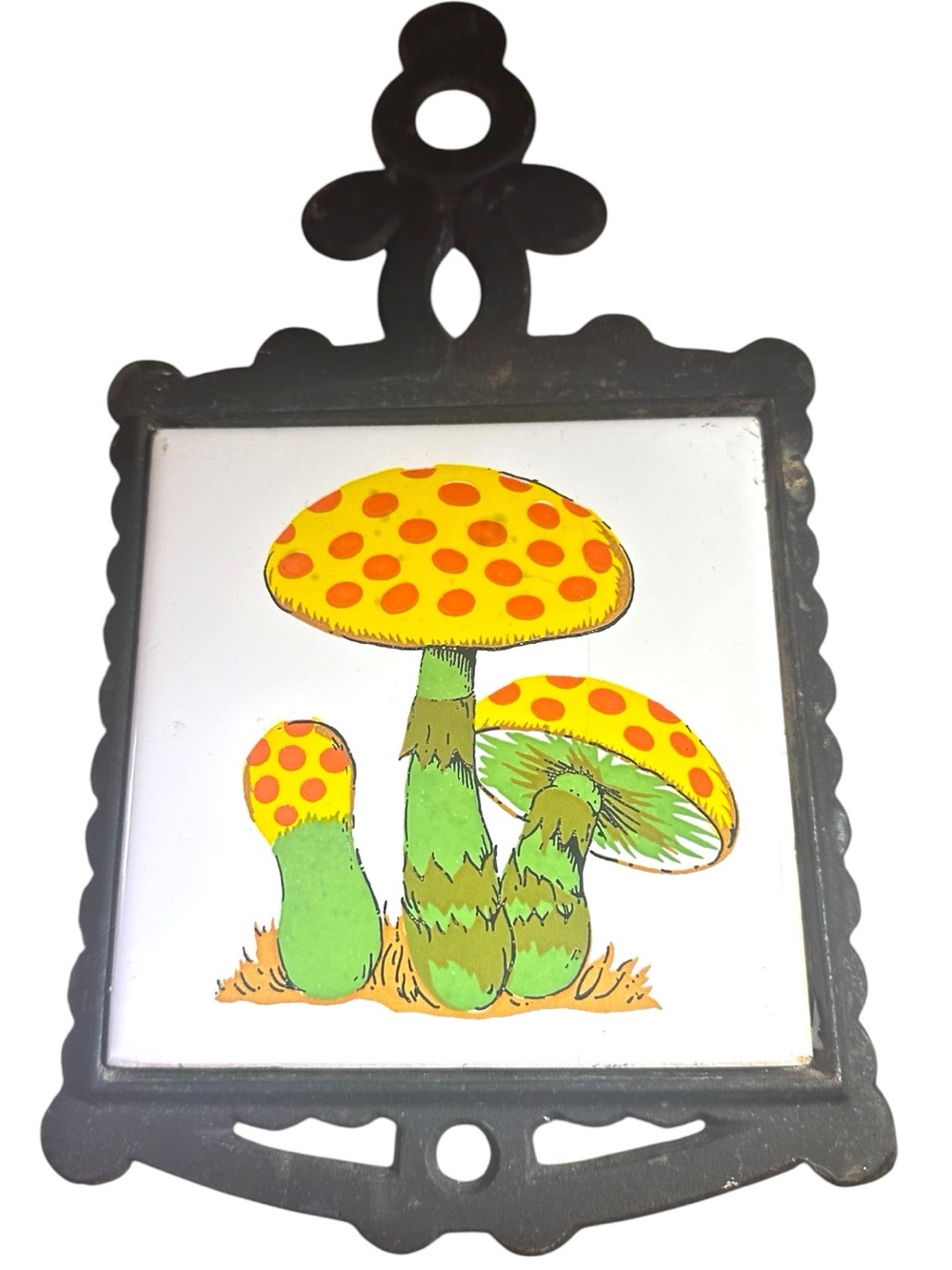 Vintage yellow and orange mushroom ceramic tile trivet, black cast iron frame.
